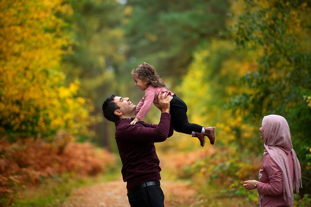 Family photo session in autumnal woods