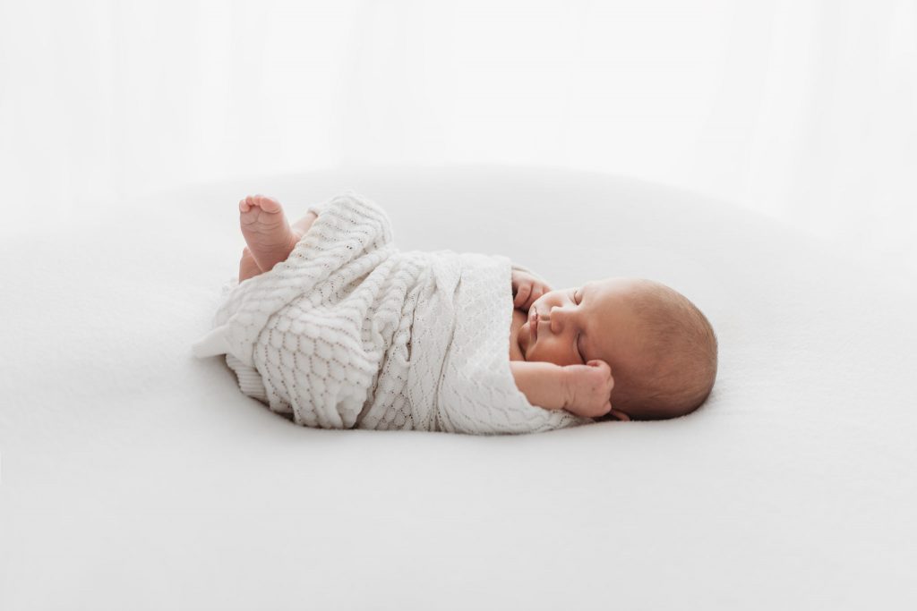 Simple and natural newborn photography in Poole. Natural posing. All white studio photography. Newborn photography at home.